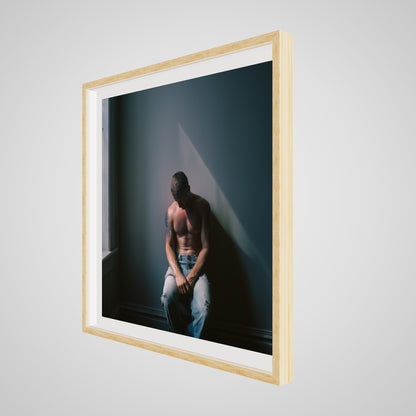 Angled view of Contemplative Male Portrait Art Print in a 36x36 deep natural square spacer frame