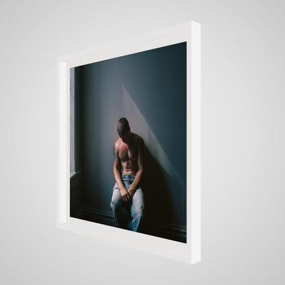 Angled view of Contemplative Male Portrait Art Print in a 36x36 deep white square spacer frame