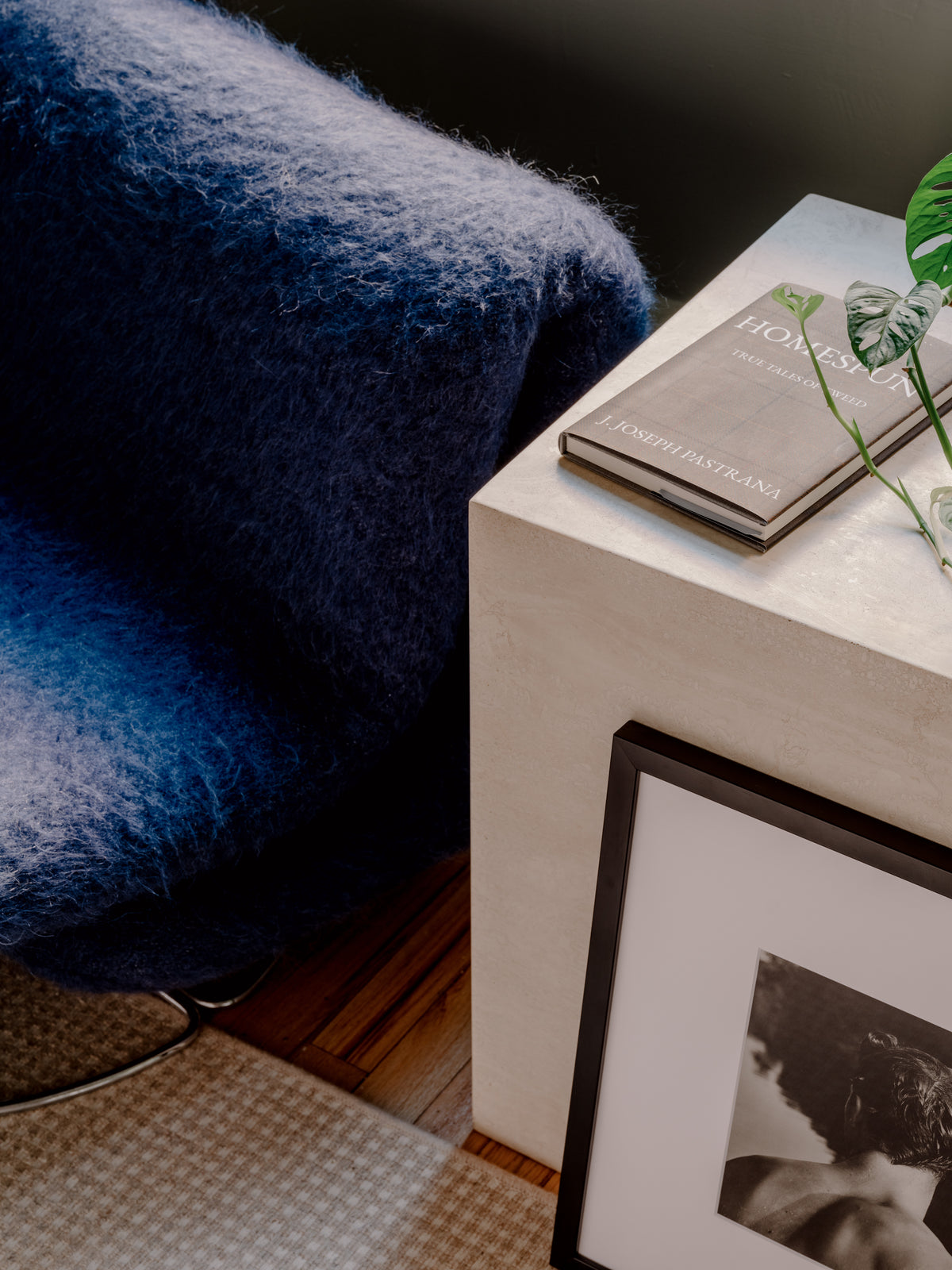 Provenance & Patina — contemporary vintage interior with blue upholstered chair, Homespun book, and framed photograph