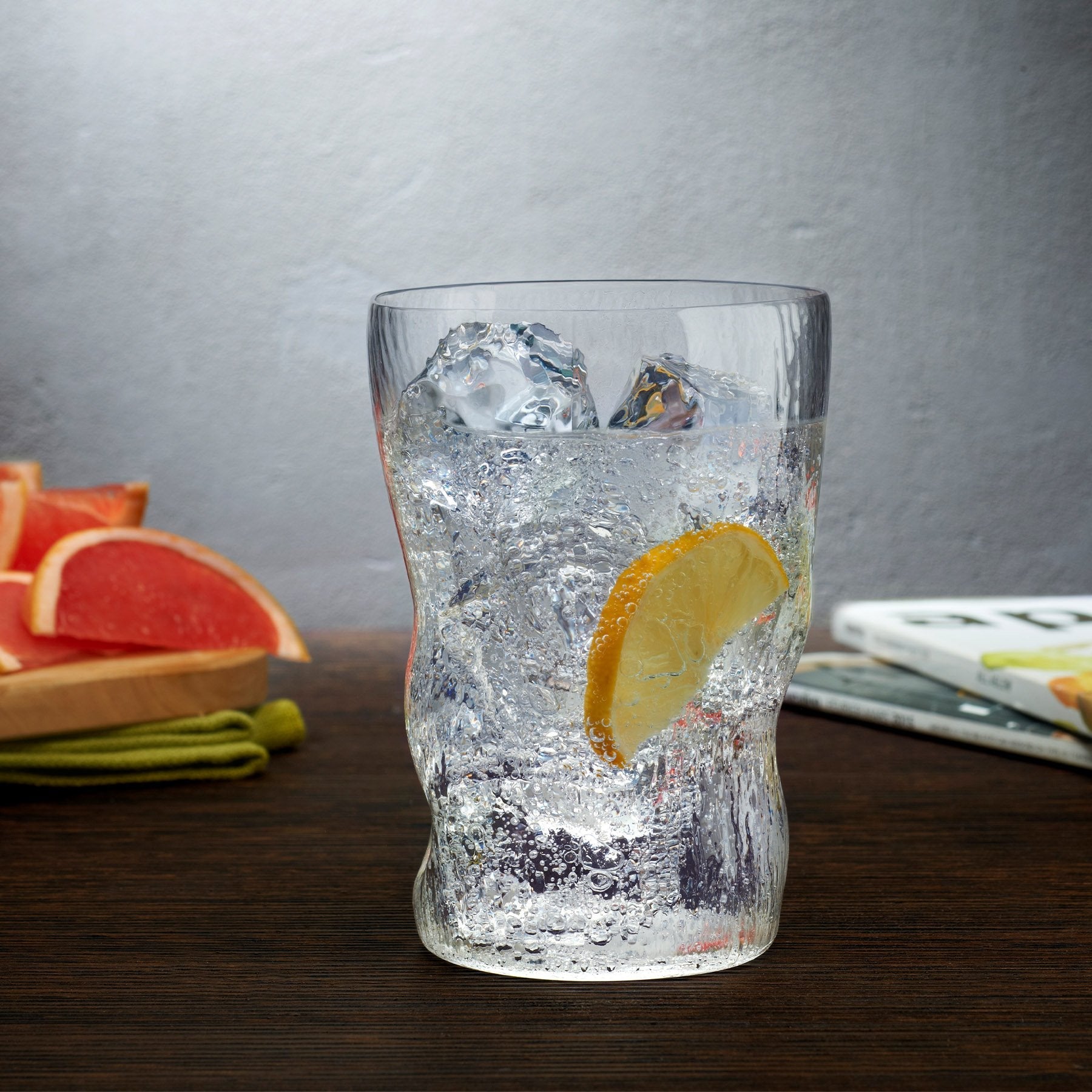 Elegant table arrangement displaying the NUDE Glass Barduck highball glasses alongside premium home bar accessories.