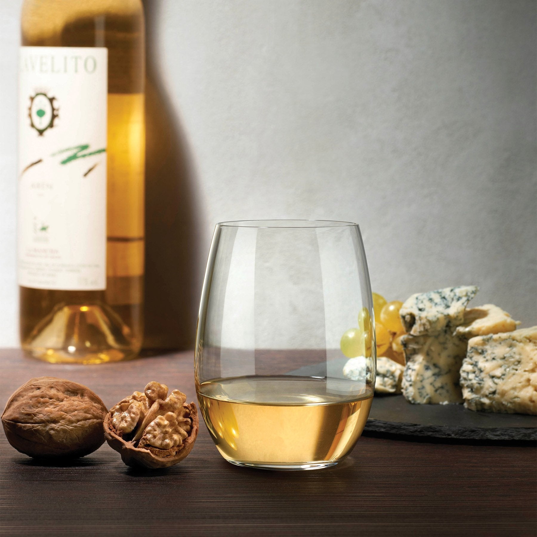 Elegant lifestyle setting featuring a NUDE Pure white wine glass on a modern tabletop.