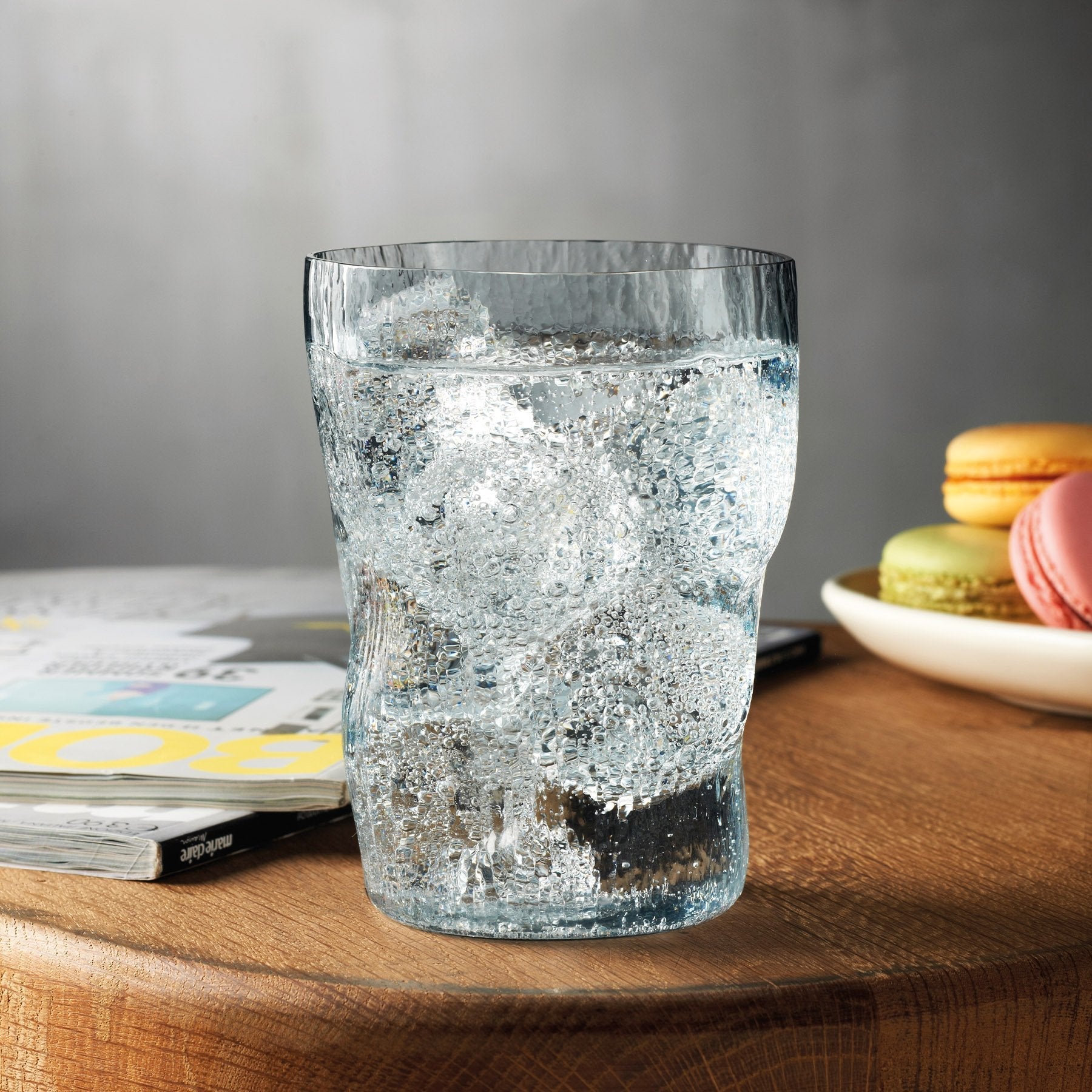 A curated modern table setting featuring the NUDE Glass Barduck long drink glasses filled with a refreshing cocktail.