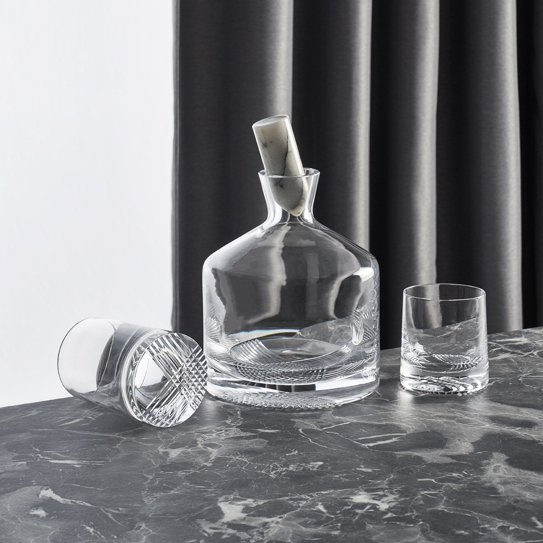 Curated lifestyle setting with the NUDE Glass Alba decanter, tumblers, and elegant bar accessories