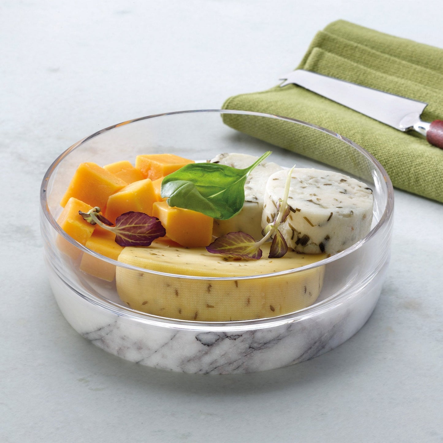 Large Chill bowl on marble base containing ice, styled on a contemporary wooden table