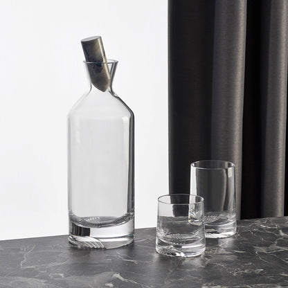 Curated barware set showcasing the Alba tall whisky bottle alongside companion crystal glasses on a dark surface.