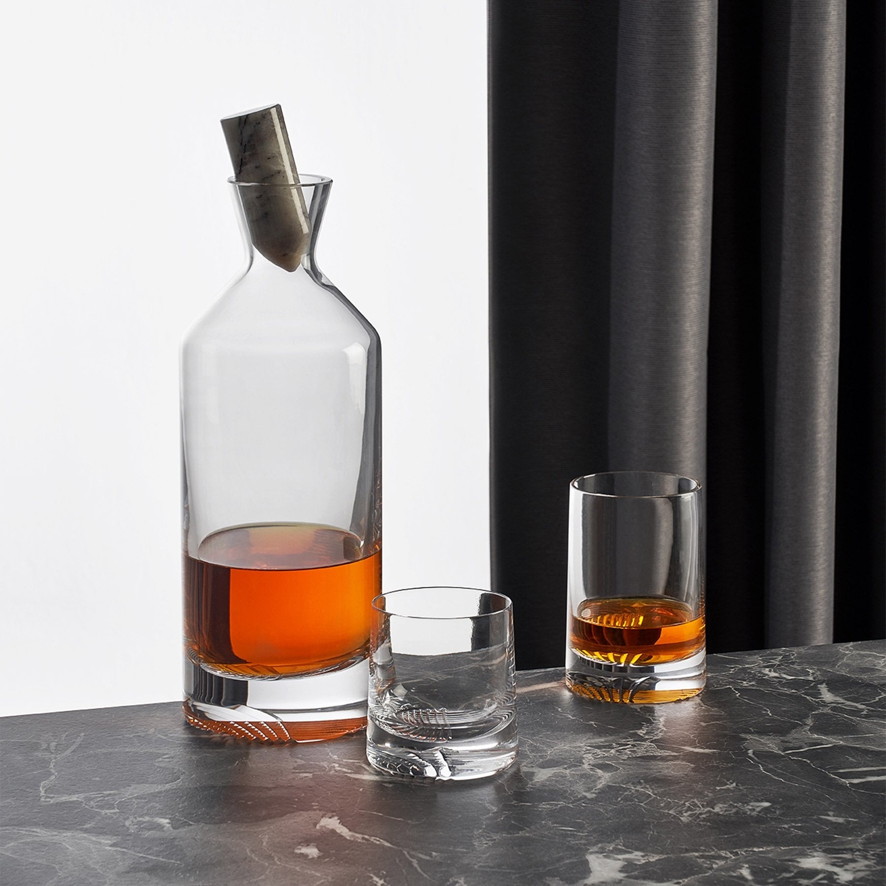 A sophisticated table layout showcasing the crystal Alba carafe and tumblers for entertaining.
