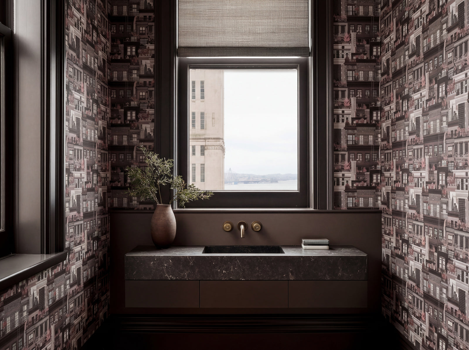 Oxblood colorway of West Village Rooftops wallpaper in a dramatic dining room.
