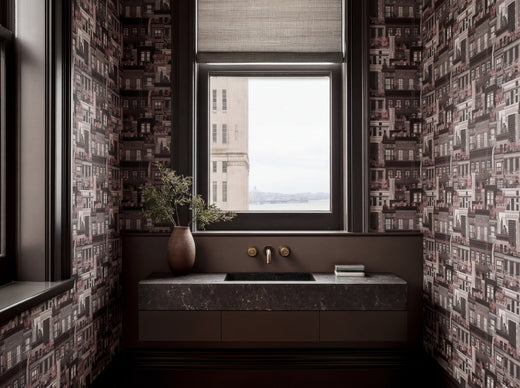 Oxblood colorway of West Village Rooftops wallpaper in a dramatic dining room.