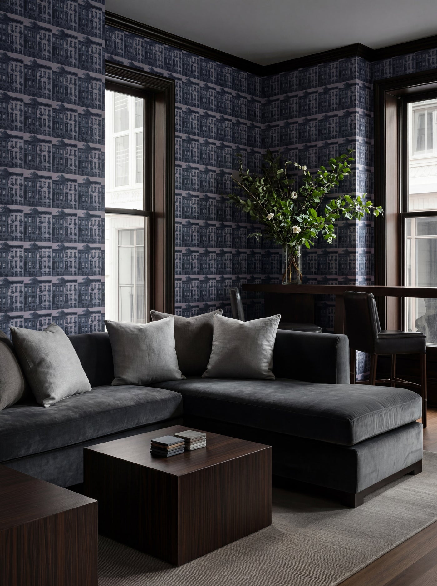 Greenwich Village wallpaper in a contemporary living room, highlighting the bold architectural pattern.