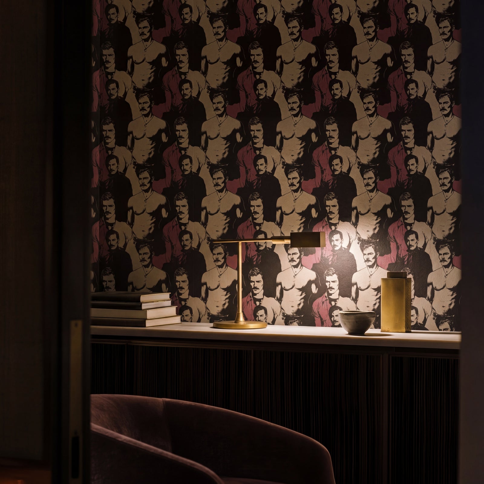 Sophisticated entryway styled with warm crimson and stone figurative wallpaper
