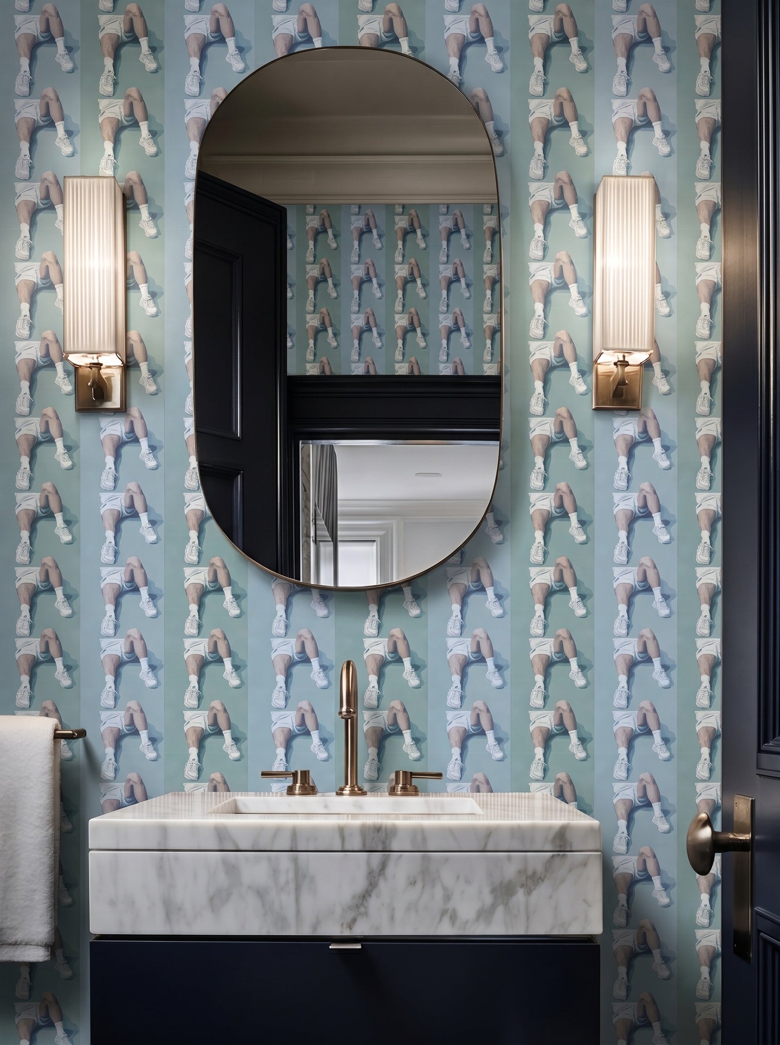 An elegant powder room featuring Court Side striped wallpaper installed on the walls.