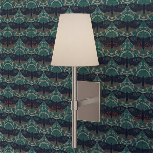 Detailed view of teal Butterfly Lattice wallpaper in a styled interior.