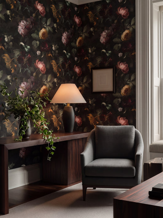 A beautifully decorated room featuring Nocturne Botanical Wallpaper on a dining room wall with elegant furnishings.