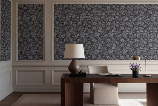 Palmy Weather wallpaper in Black colorway styled in an elegant dining room with natural wood decor.