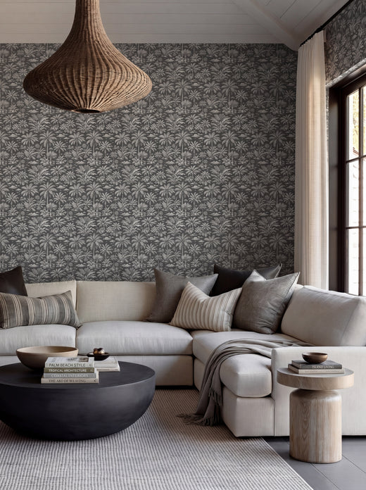 Elegant room setting featuring Palmy Weather Charcoal wallpaper paired with a classic console table.
