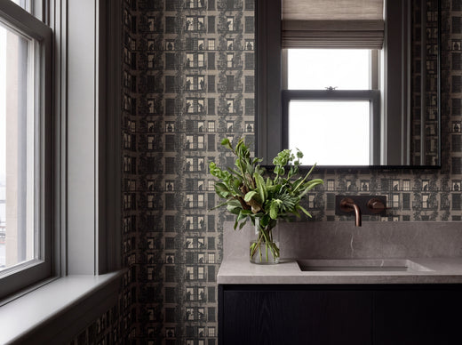 Taupe wallpaper rolls arranged to showcase pattern alignment.