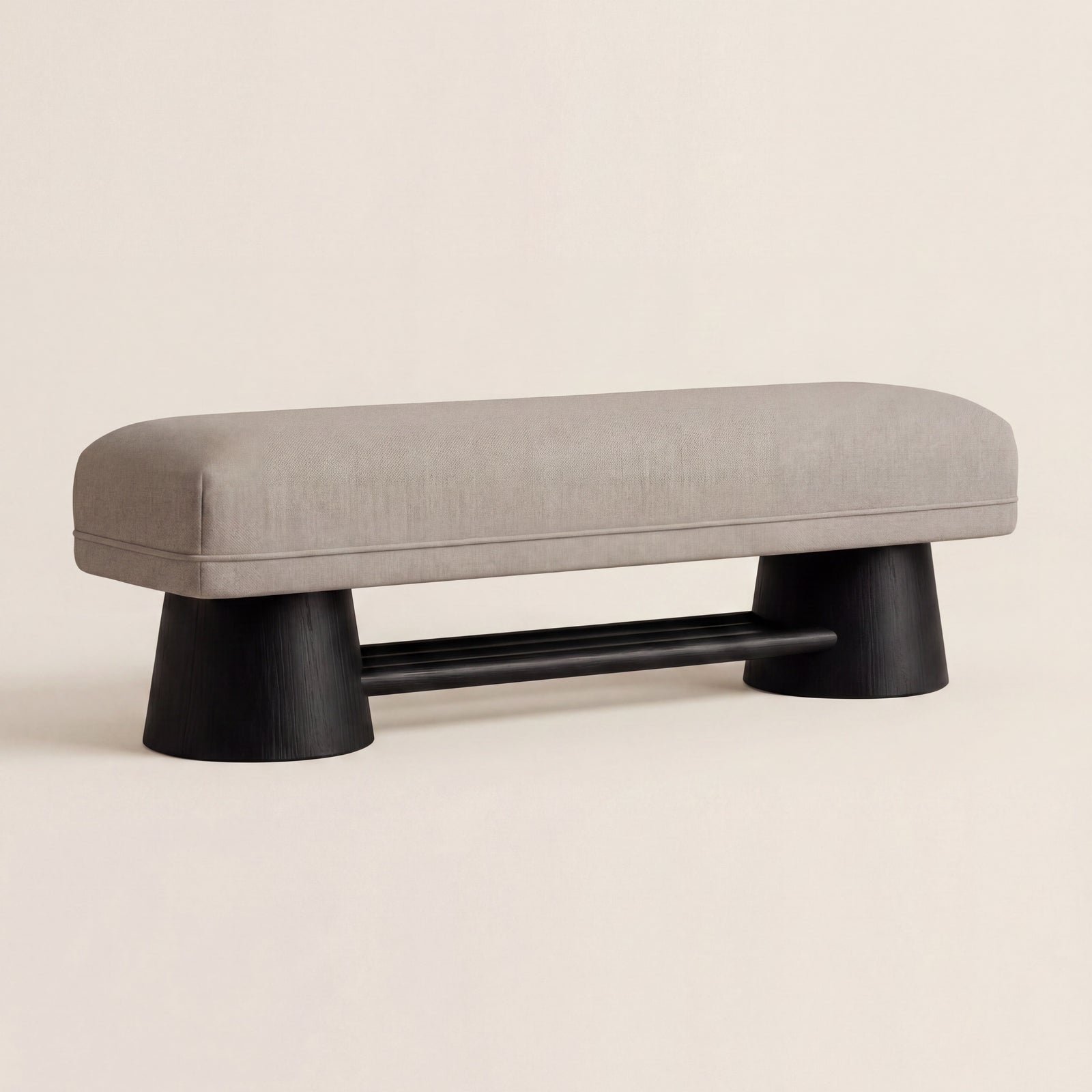 Harbour custom upholstered bench with a matte walnut base, shown in light neutral fabric.
