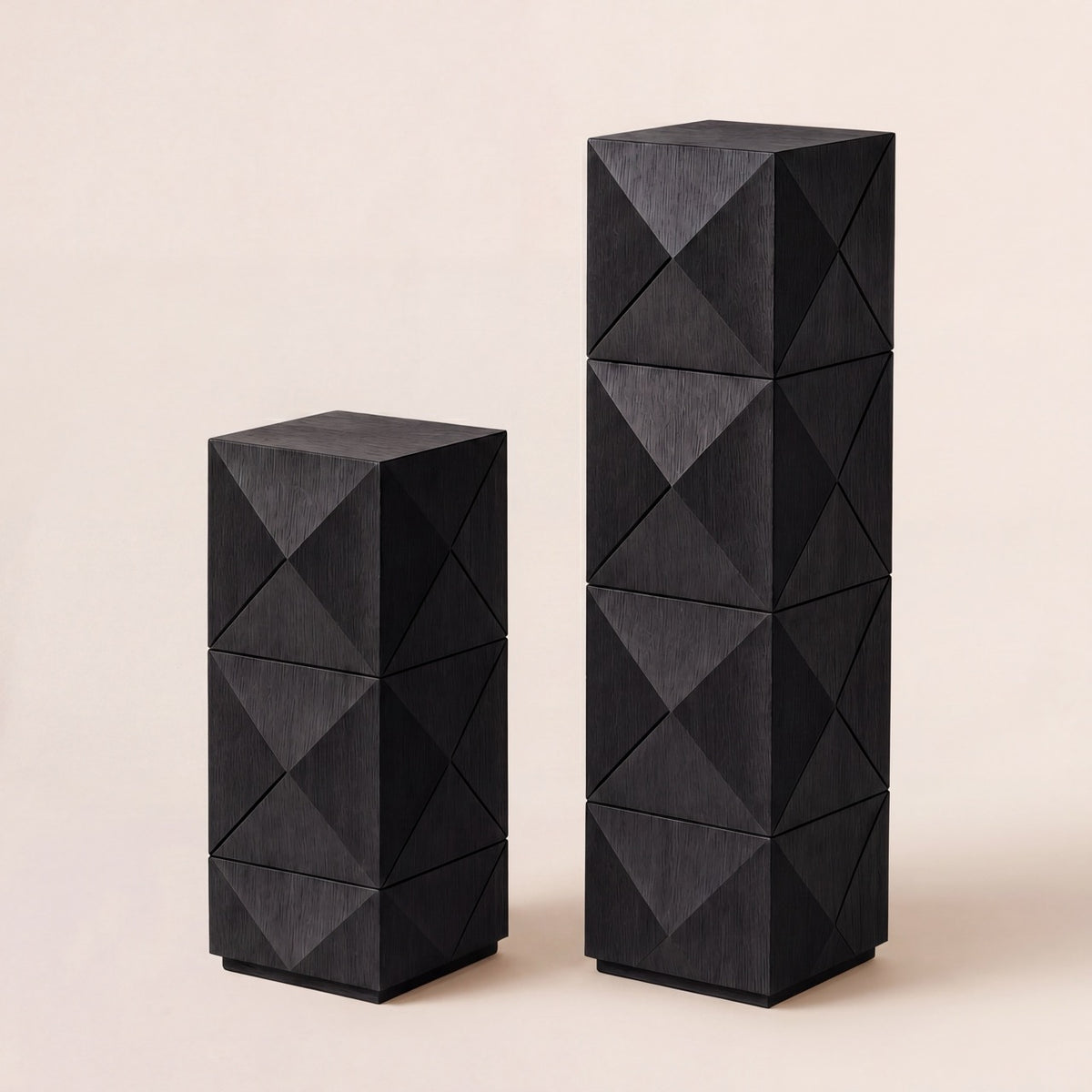 Pair of custom wood display pedestals in short and tall sizes with geometric diamond panels.
