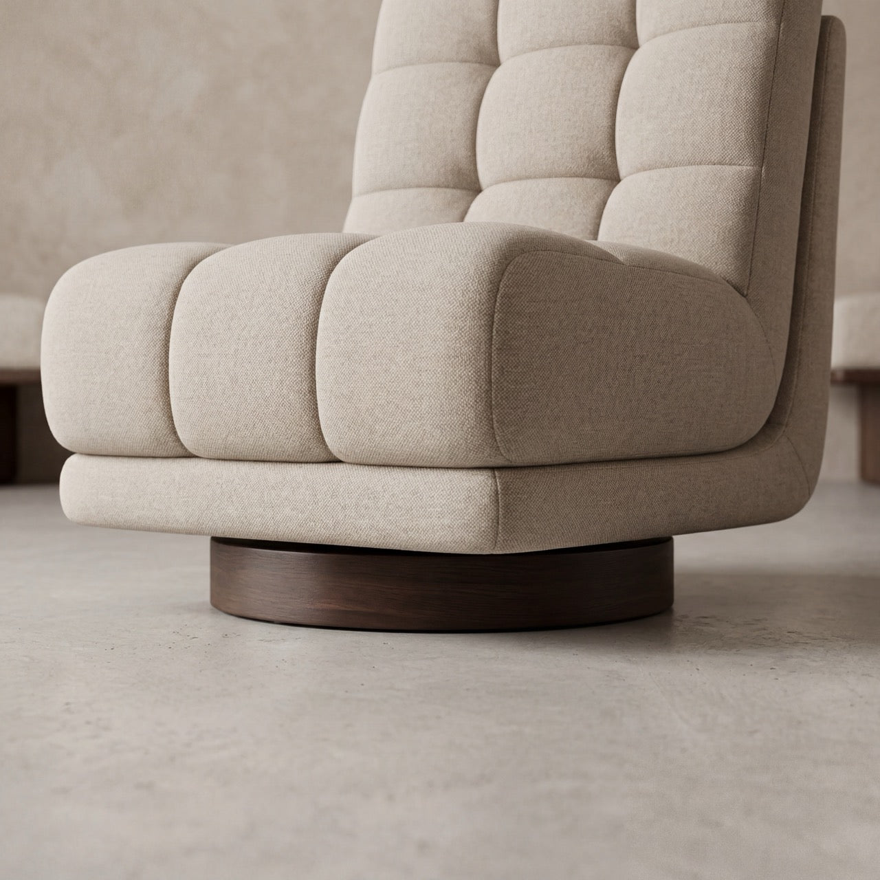 Side profile of the custom upholstered Puffer lounge chair highlighting its elegant curves.