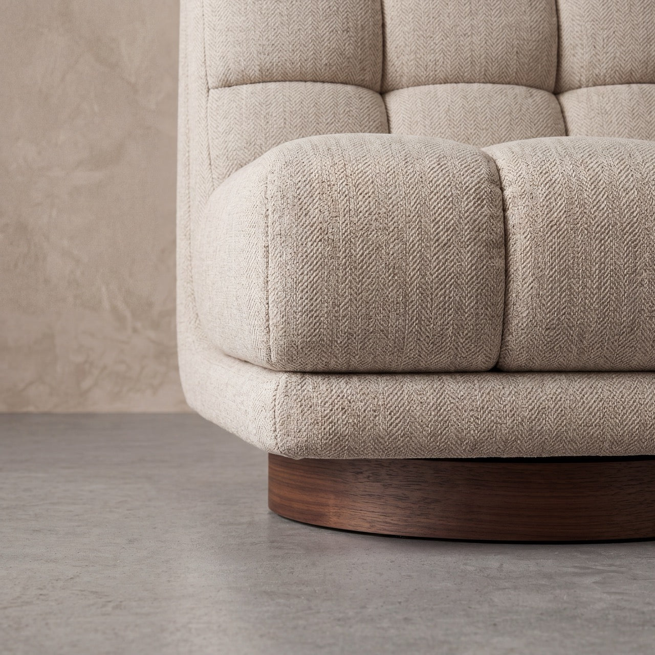 Rear view of the Puffer swivel lounge chair showing seamless fabric tailoring.