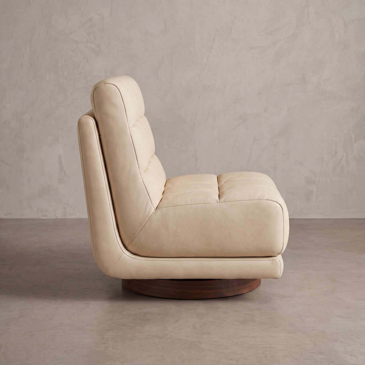 Detailed shot of the custom wood swivel base on the Puffer armchair.