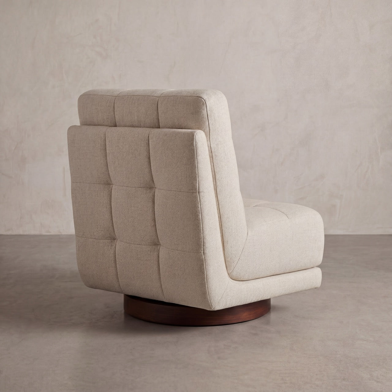 Close-up of the fabric texture and expert upholstery on the Puffer swivel chair.