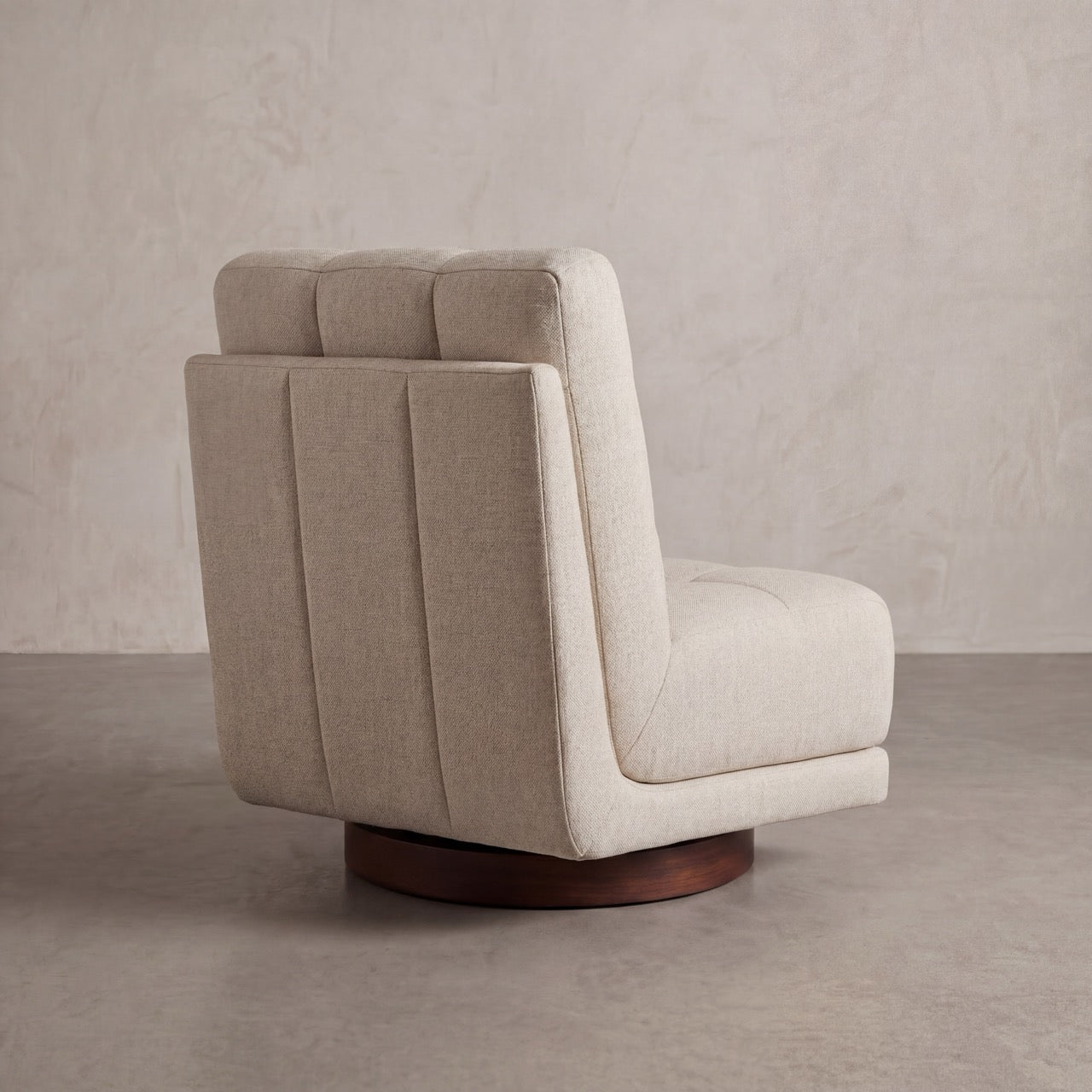 Detail of the tufted backrest on a custom-upholstered Puffer swivel armchair.