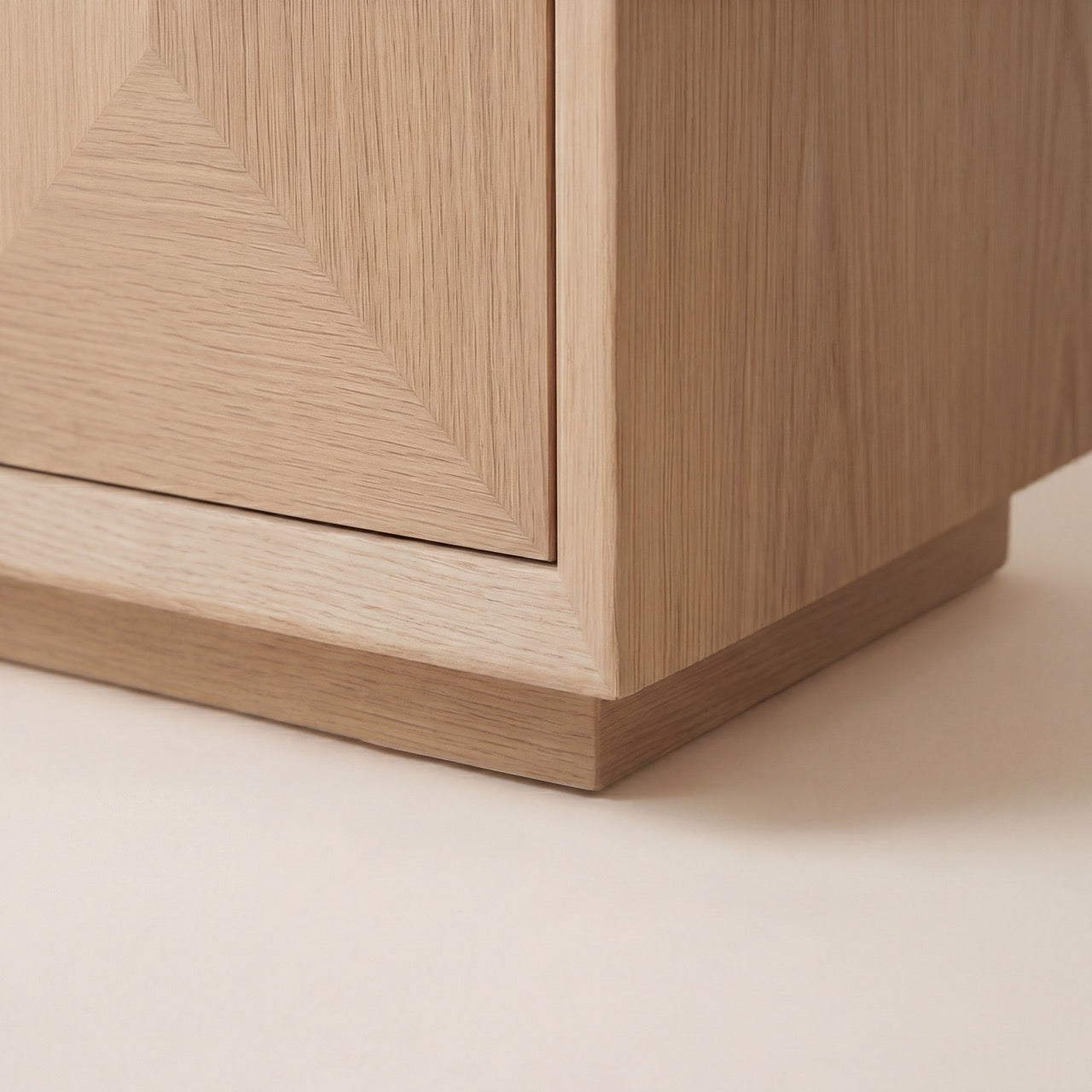 Side profile of the modern Studio cabinet-style bedside table in a matte finish.