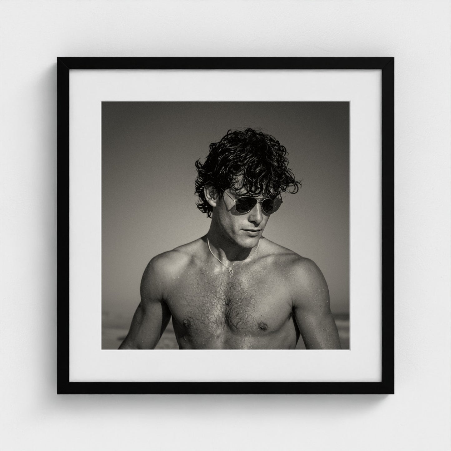 The fine art coastal portrait print styled in a 20x20 inch contemporary black frame.
