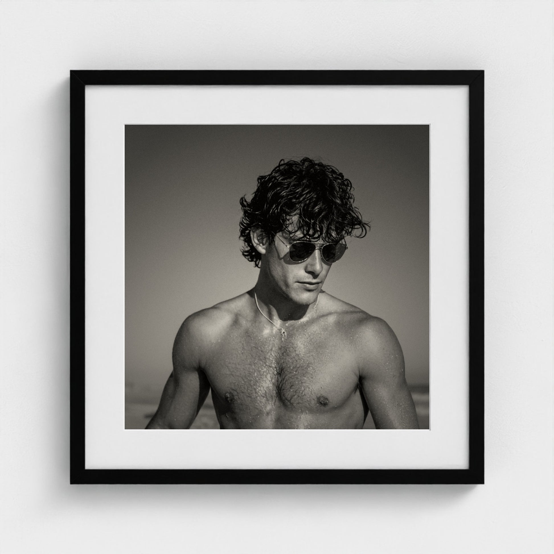 The fine art coastal portrait print styled in a 20x20 inch contemporary black frame.