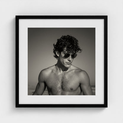 The fine art coastal portrait print styled in a 20x20 inch contemporary black frame.