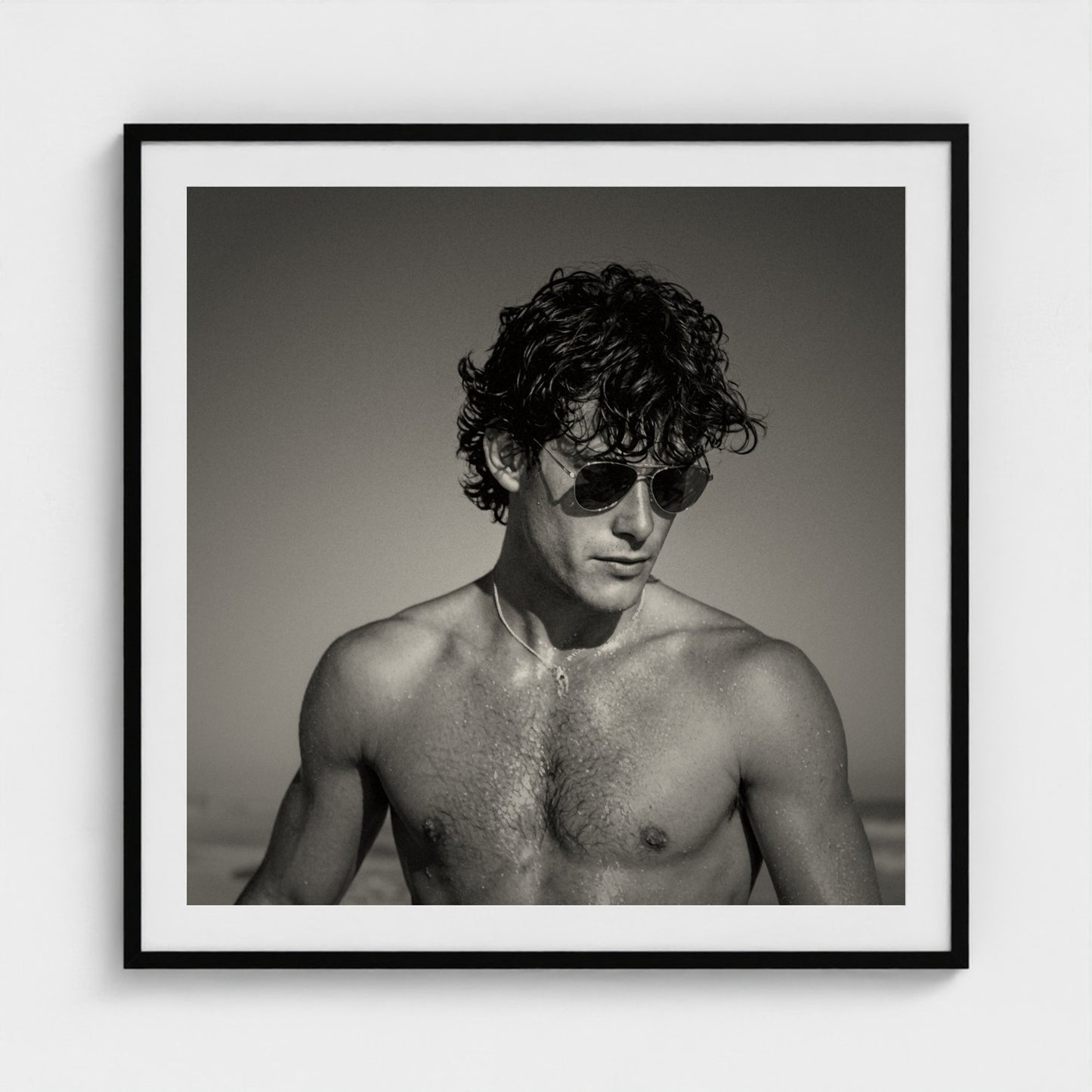 The Coastal Gaze portrait print displayed in a 36x36 inch black frame on a gallery wall.