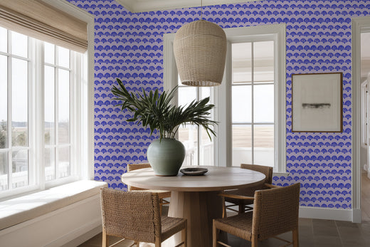 The Modern Scallop wallpaper in a rich purple hue in a designer dining room.