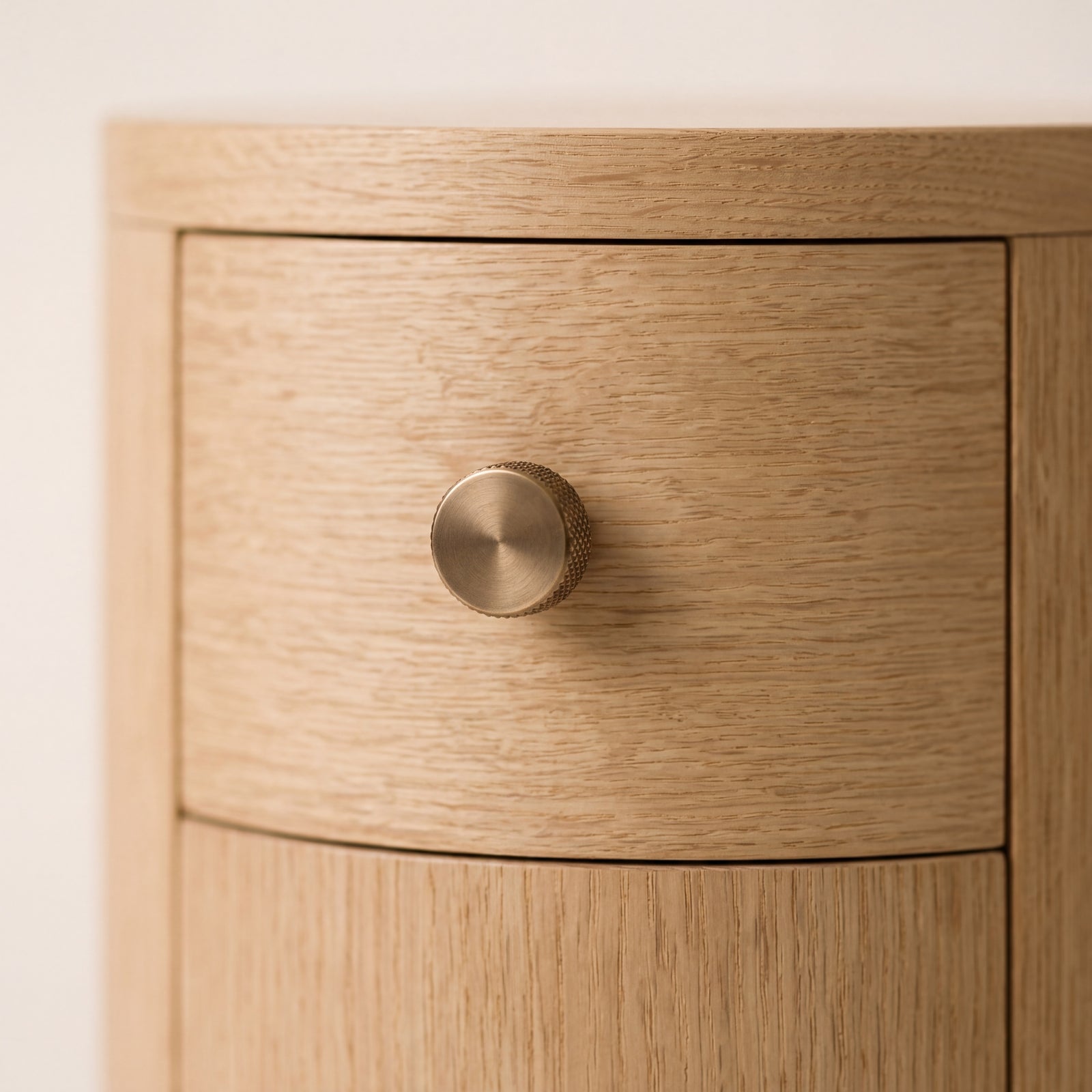 Detail of the custom brass hardware on the natural finish ash nesting table.