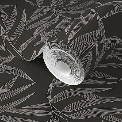 Roll of white paper with a leaf pattern on a black background