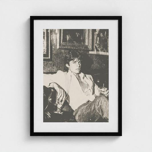 Contemplative Portrait on Leather Sofa in Monochrome