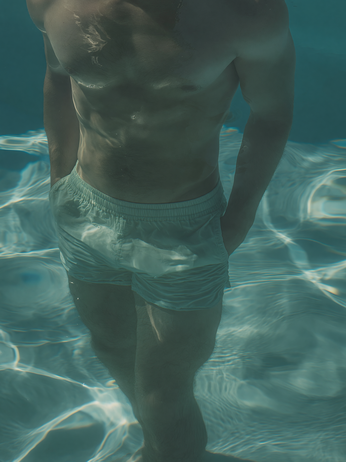 3D Source Artwork - Under Water Trunks male swimmer in white trunks beneath teal water