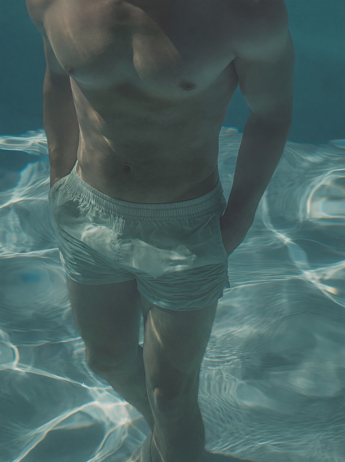 High-resolution framed view of 3D Source Artwork - Under Water Trunks male swimmer in white trunks beneath teal water