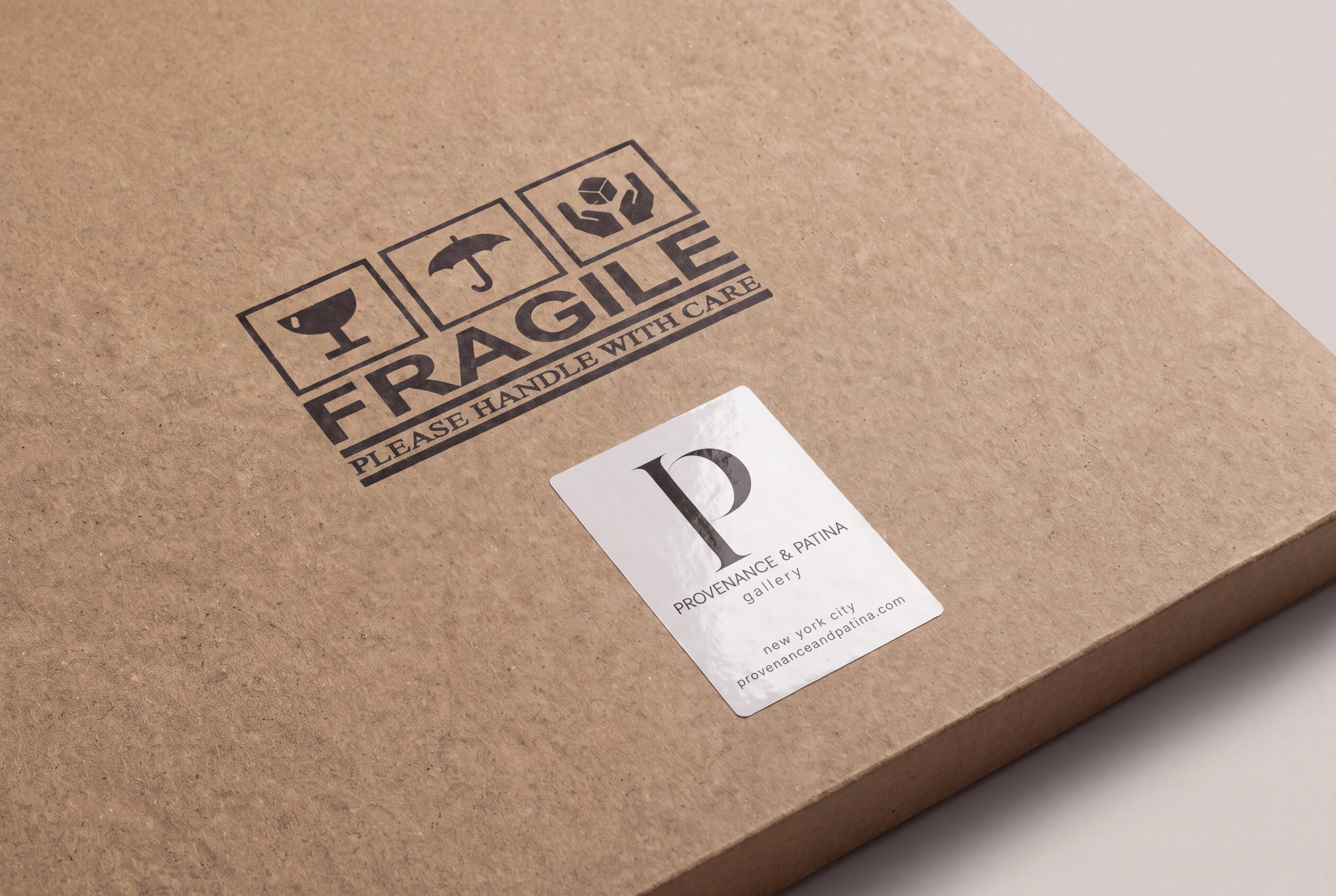 Protective kraft cardboard artwork packaging marked Fragile with a glossy Provenance and Patina gallery label